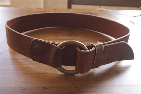 laws of general economy: Vintage leather brass belt