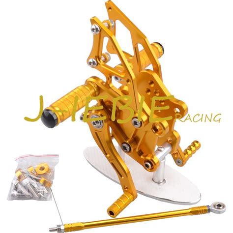 an image of a gold fishing reel and spooler with screws on it