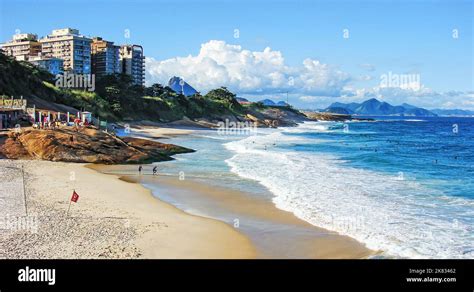 A view of the Copacabana beach in Rio de Janeiro, Brazil with surfers in the waves of the ...