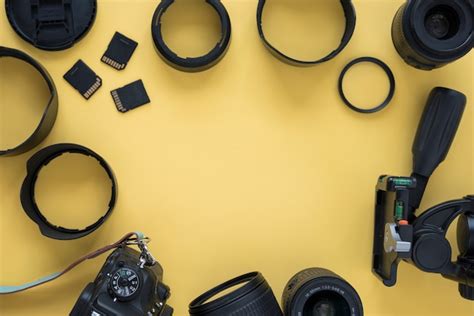 Free Photo | Professional dslr modern camera with camera accessories over yellow background