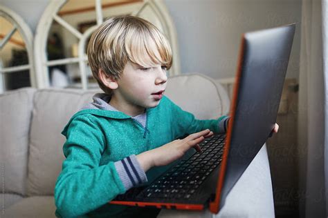 "Child Using A Laptop" by Stocksy Contributor "Sally Anscombe" - Stocksy