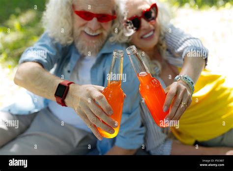 Selective focus of glass bottles clinked together Stock Photo - Alamy
