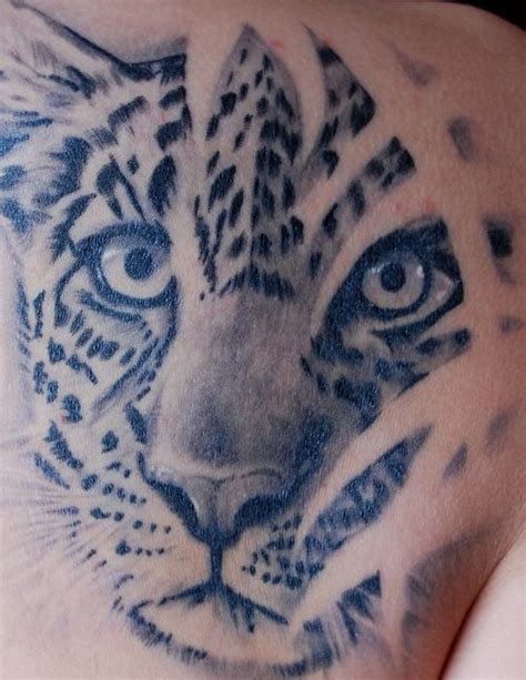 Leopard face tattoo