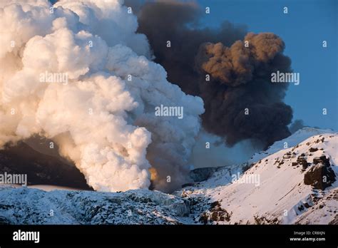 Cloud of ash from Eyjafjallajoekull volcano and a steam plume from the ...