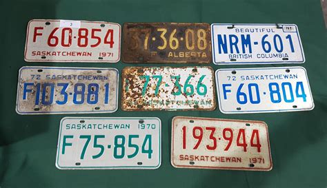 EIGHT VINTAGE LICENSE PLATES