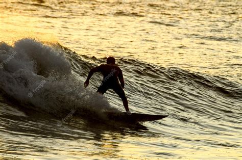 Premium Photo | Silhouette surfer at sunset