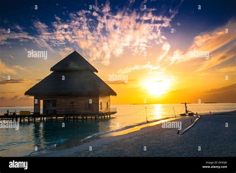 Sunset on Maldives island Stock Photo - Alamy