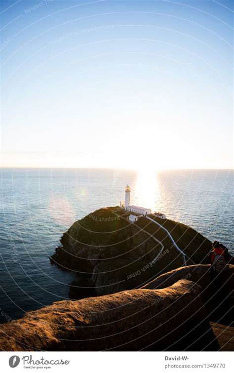 Lighthouse at sunset Ocean - a Royalty Free Stock Photo from Photocase