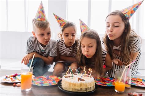 Kids blowing out birthday candles together Photo | Free Download