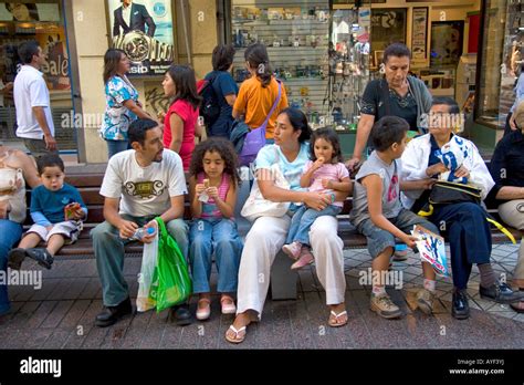 People sit on benches in Santiago Chile Stock Photo - Alamy