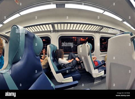 LIRR train interior, with passengers sitting waiting to leave Penn Station, NYC, to go to Long ...