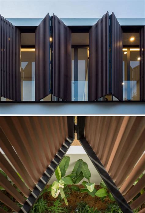 an open air house with wooden slats on the outside and inside, as well as plants