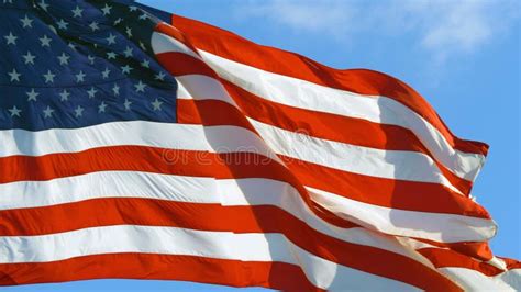 American Flag Flying in the Wind at Sunny Day. Stock Photo - Image of nylon, wallpaper: 200518674