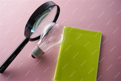 Premium Photo | Magnifying glass and light bulb and note pad