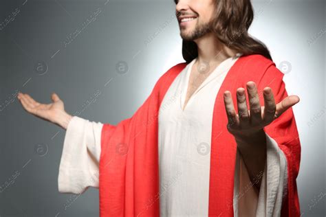 Jesus Christ reaching out his hands on grey background, closeup: Stock Photo | Download on ...