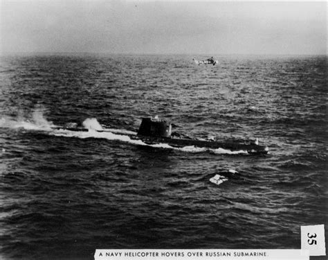 US Navy helicopter flies above a Soviet F-class submarine (B-59 ...