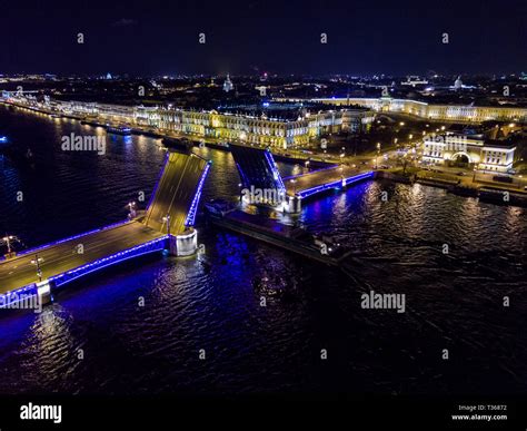 Summer night, Saint Petersburg, Russia. Neva River. A ship passes under drawn bascule moveable ...