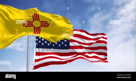 New Mexico state flag waving with the american flag ion a clear day ...