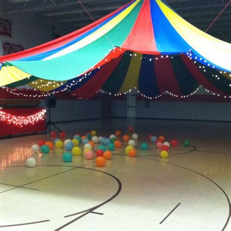 Middle school dance decorating idea.... Parachute hung from ceiling & trimmed with Christmas li ...