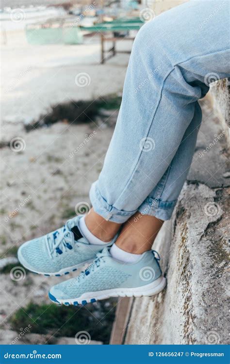 Close-up of Female Legs in Blue Rolled Up Jeans and Sneakers Stock Image - Image of outside ...