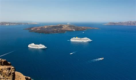 Premium Photo | Cruise ship near volcano on island of santorini