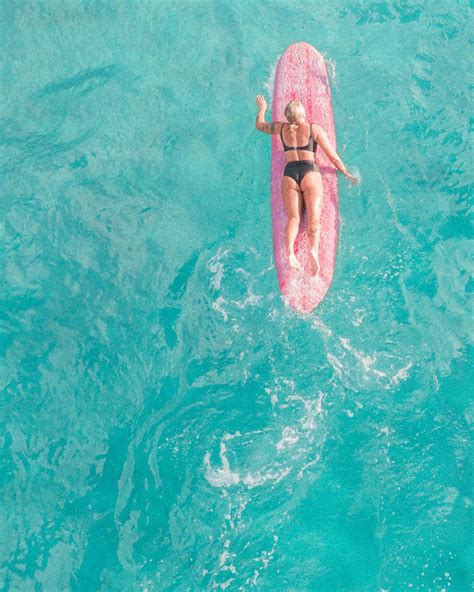 Woman in Pink Bikini Lying on Pink Inflatable Float on Water · Free Stock Photo