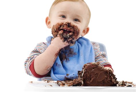 A messy baby eating his chocolate cake - ODEA Marketing