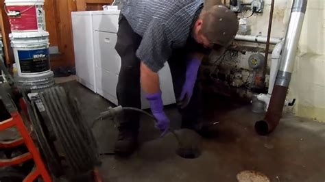 How to use a sewer snake to unplug a clogged drain pipe - YouTube