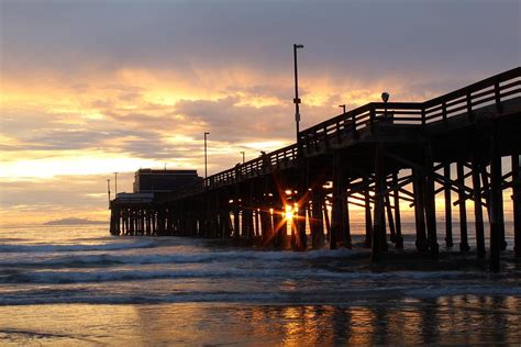 Newport Beach Pier Sunset with Sunburst Photograph by Keith Moore - Pixels