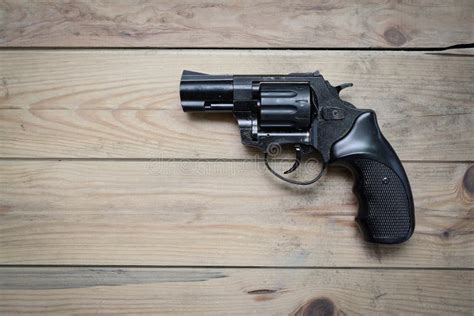 Gun on a wooden table stock image. Image of background - 76063337