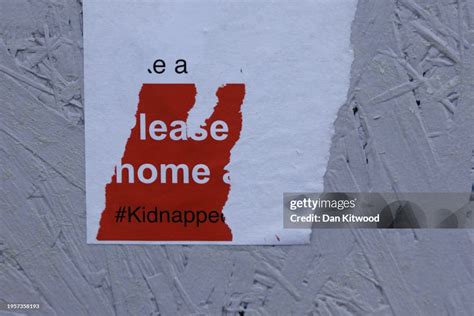 The remains of posters of Israeli Hostages on a wall in central ...