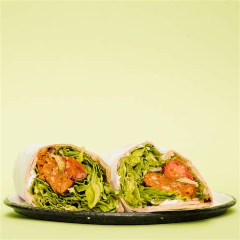 Free Photo | Burrito wraps on plate over mint green background