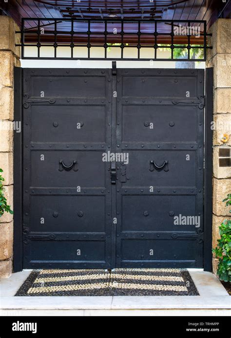 Black painted iron garden gate Stock Photo - Alamy