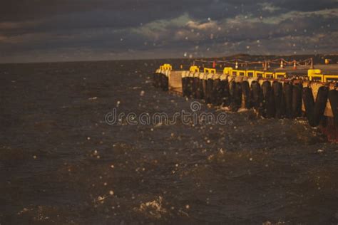 Pier in the sea in a storm stock image. Image of flow - 132620697