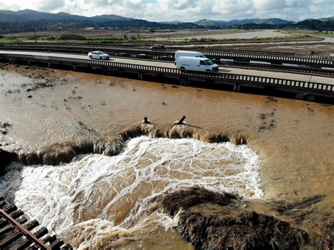 Atmospheric river unloads record rainfall on California, spurring ...