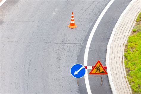 Turn Left Sign on the Road. Warning Signs and Orange Safety Traffic ...