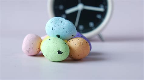 Easter concept with egg and a clock on table 23668723 Stock Video at Vecteezy