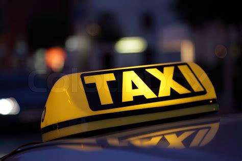 Taxi sign illuminated at night | Stock image | Colourbox