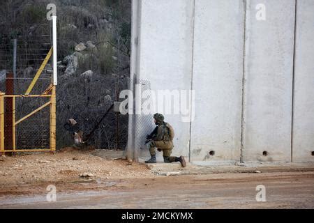 An Israeli soldier takes positions on the Israel-Lebanon border painted ...