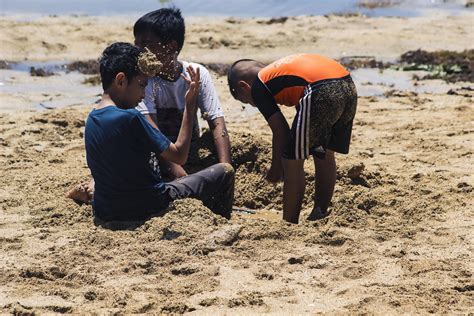 Sorong, Indonesia 2021- People on the beach 3363917 Stock Photo at Vecteezy