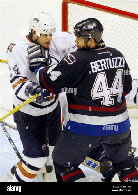 Edmonton Oilers' Steve Staios, left, and Vancouver Canucks' Todd Bertuzzi collide in front of ...