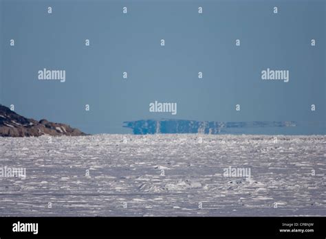 Polar Mirage (aka Superior Mirage) over ice field at sea off coast of Svalbard (Spitsbergen ...