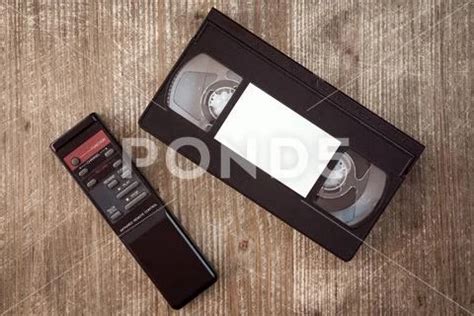 Photograph: VHS cassette and remote control VHS video tape cassette and remote control... #227891082