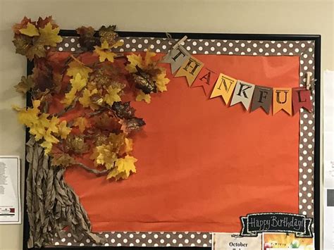 a bulletin board decorated with fall leaves