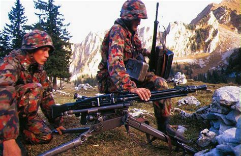 Swiss Infantrymen set up the Swiss copy of the German MG42 Machine-Gun during a training ...