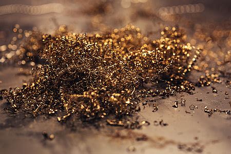 Royalty-Free photo: Close-ups of golden metal shavings on a table | PickPik