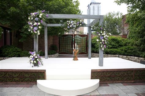 Gray Wooden Wedding Arch with Purple Flowers