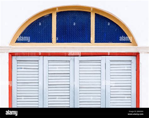 Wooden folding doors with the color glass frame of the Thai church Stock Photo - Alamy