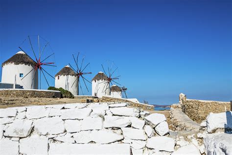 Traditional Windmills Of Mykonos Photograph by Deimagine | Fine Art America