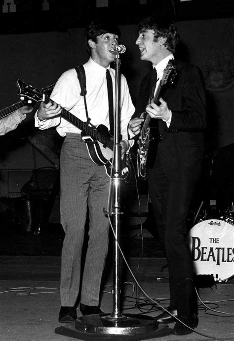 Paul McCartney and John Lennon singing together during a recording ...